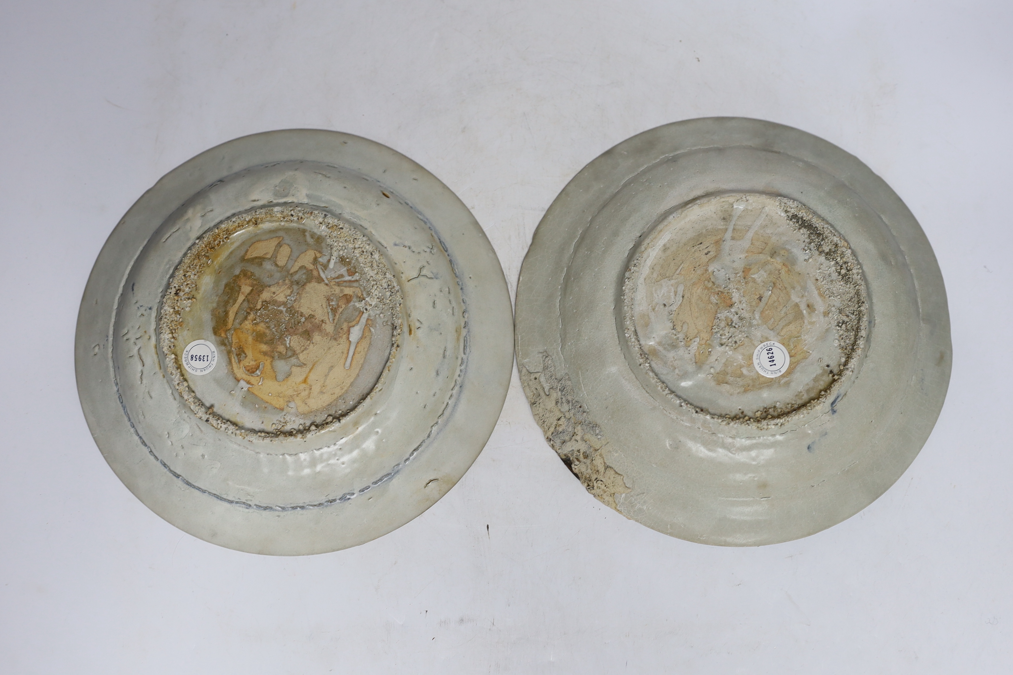 A pair of Chinese Swatow blue and white 'phoenix' plates, late Ming, Binh Thuan shipwreck, 26cm diameter (a.f.)